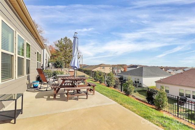 view of patio / terrace with a residential view and fence