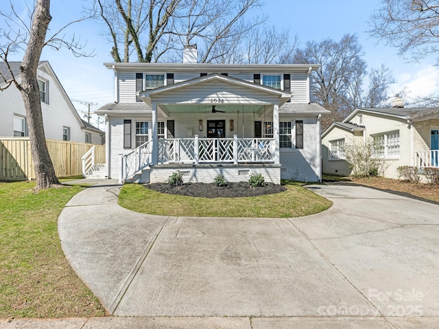 view of front of house with driveway, covered porch, a chimney, and brick siding