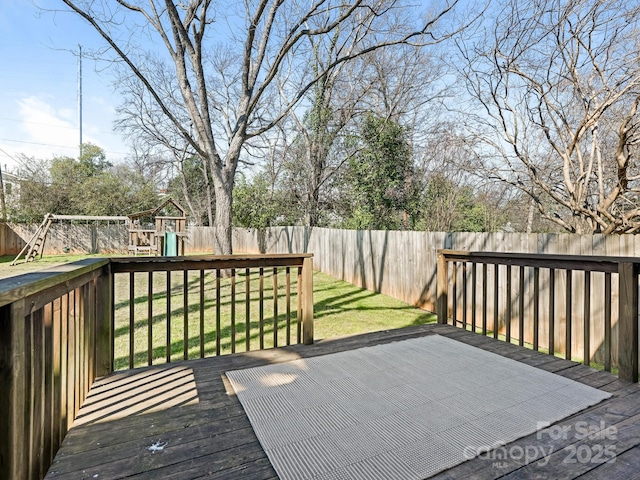 wooden deck with a fenced backyard, a playground, and a yard