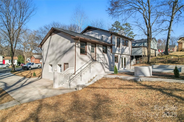 exterior space with brick siding and a chimney