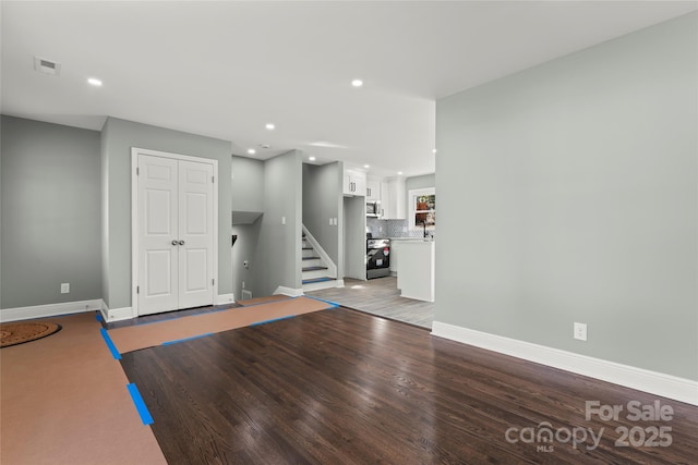 interior space with recessed lighting, visible vents, stairway, light wood-style floors, and baseboards