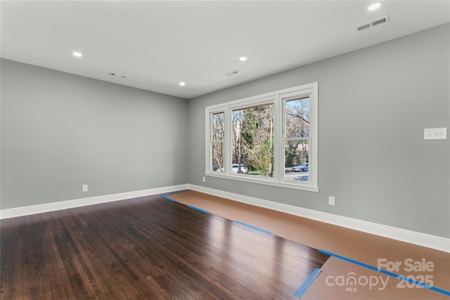 spare room with baseboards, visible vents, and recessed lighting