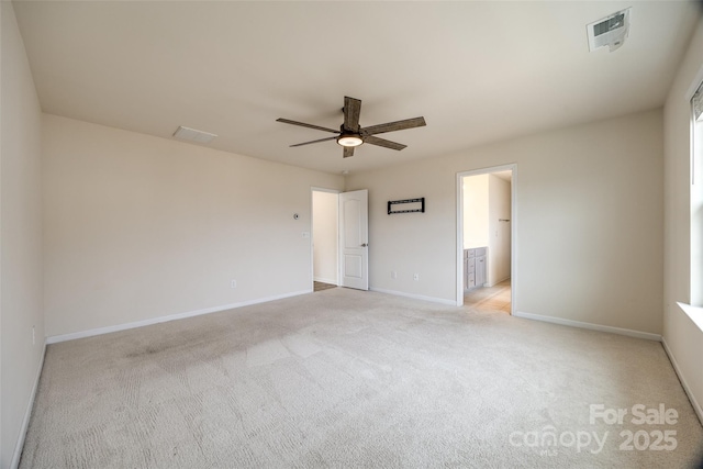 unfurnished bedroom featuring a ceiling fan, visible vents, baseboards, ensuite bathroom, and light carpet