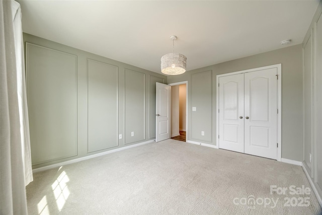 unfurnished bedroom featuring baseboards and carpet floors