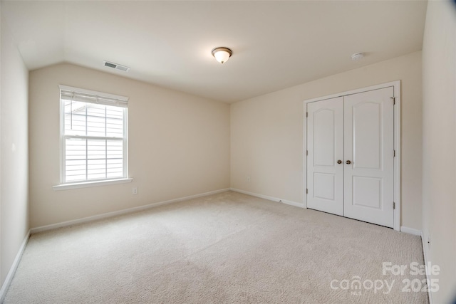 unfurnished bedroom featuring visible vents, baseboards, a closet, and carpet flooring