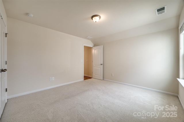 spare room with visible vents, carpet flooring, and baseboards