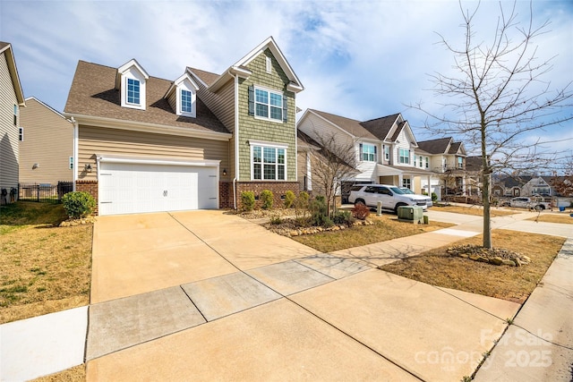 view of front of property featuring brick siding, a residential view, driveway, and a garage