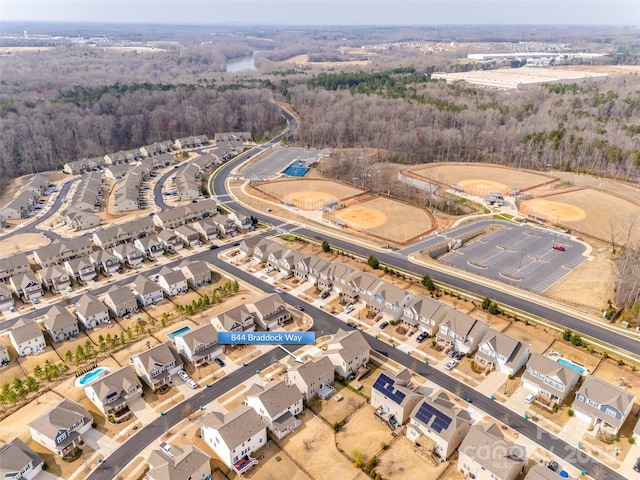 aerial view featuring a view of trees and a residential view