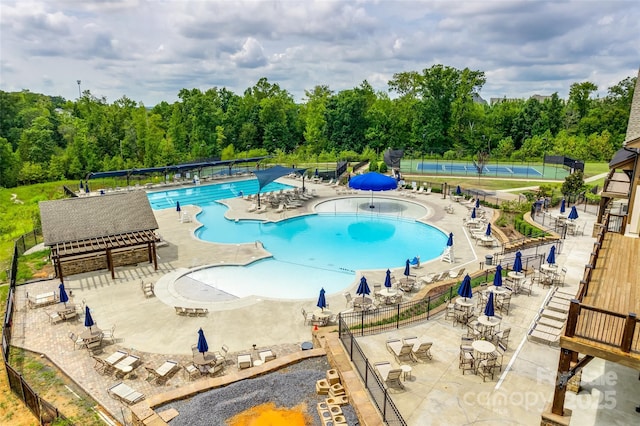 pool featuring a patio and fence