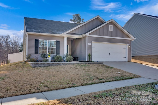 view of front of home featuring concrete driveway, an attached garage, fence, and a front yard