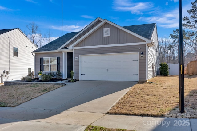 view of front of property featuring a garage, concrete driveway, fence, and board and batten siding