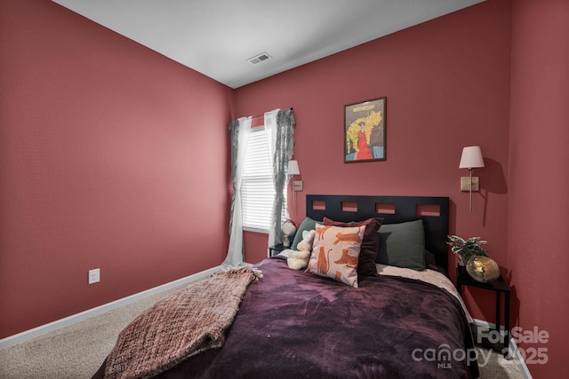 carpeted bedroom with visible vents and baseboards