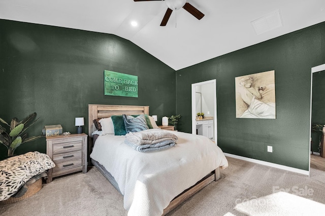 carpeted bedroom featuring lofted ceiling, visible vents, ceiling fan, ensuite bath, and baseboards