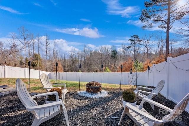 view of yard featuring an outdoor fire pit and a fenced backyard