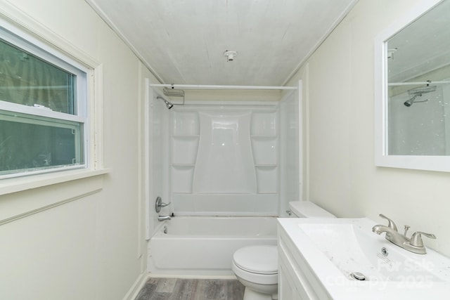 bathroom featuring toilet, vanity, wood finished floors, and bathing tub / shower combination