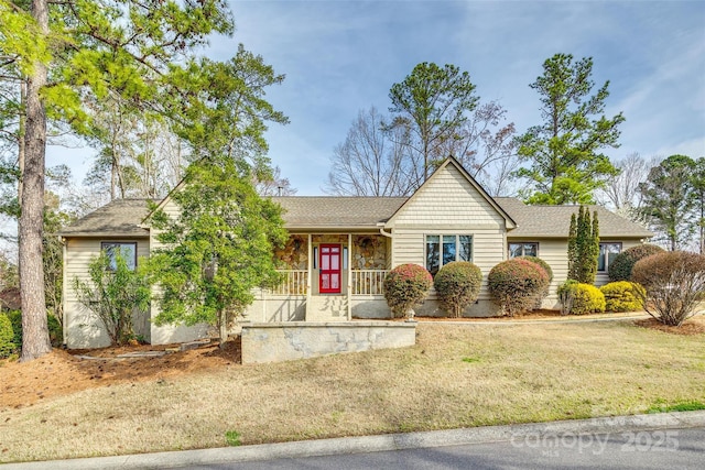 ranch-style home featuring a front lawn, a porch, stone siding, and a shingled roof