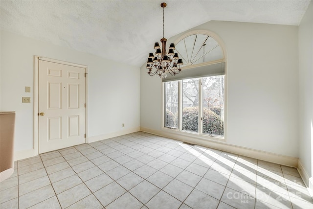 unfurnished room with a notable chandelier, a textured ceiling, light tile patterned floors, baseboards, and vaulted ceiling