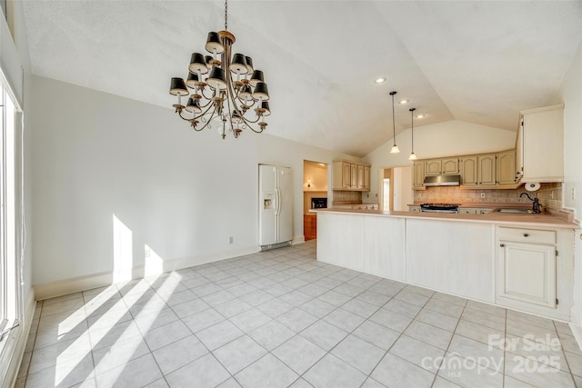 kitchen featuring under cabinet range hood, tasteful backsplash, white fridge with ice dispenser, light tile patterned flooring, and range