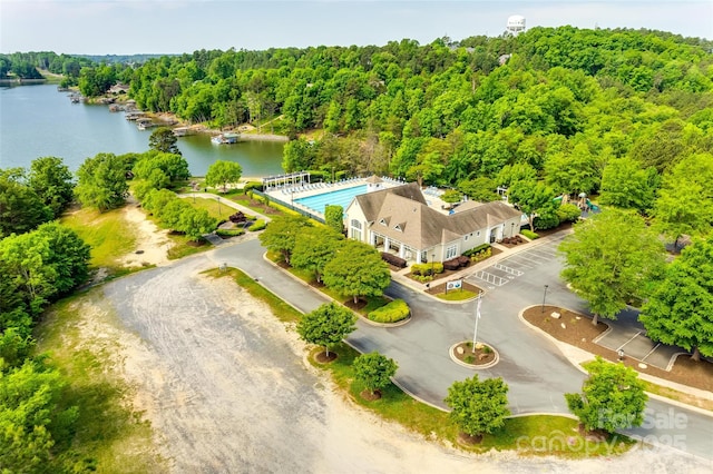 drone / aerial view featuring a water view and a wooded view