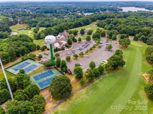 bird's eye view with view of golf course and a water view