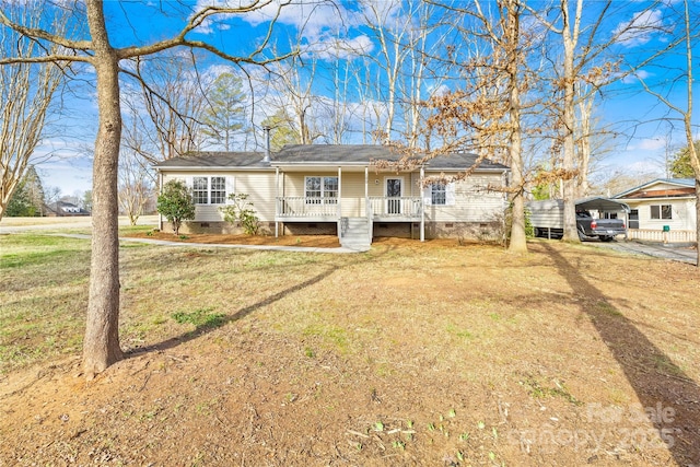 single story home with a carport, a porch, crawl space, and a front lawn