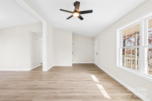 unfurnished living room with lofted ceiling, light wood-style floors, baseboards, and a ceiling fan