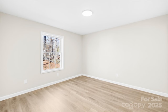 unfurnished room featuring light wood-type flooring and baseboards