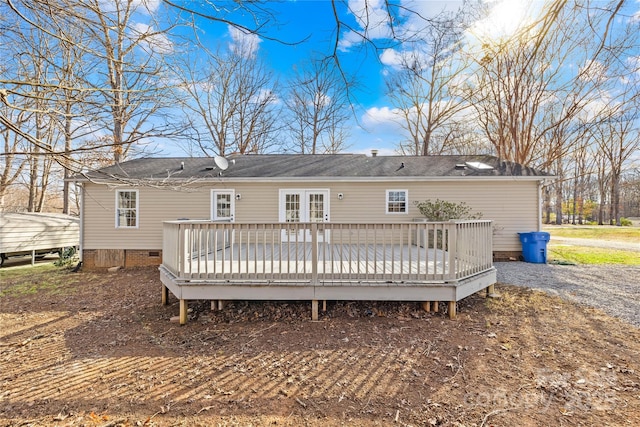 back of house with crawl space and a deck