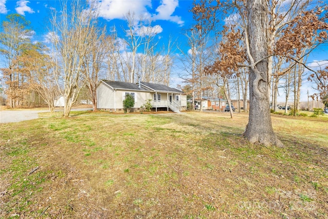 view of front of home with crawl space and a front lawn