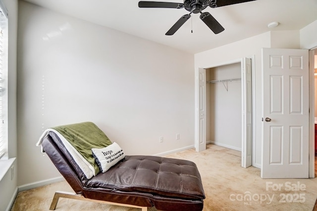 living area with ceiling fan, carpet flooring, and baseboards