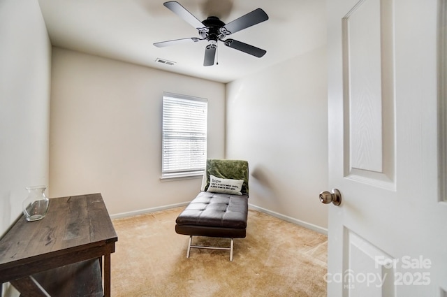 living area with carpet floors, baseboards, and visible vents