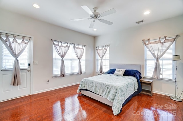 bedroom with recessed lighting, wood-type flooring, and baseboards