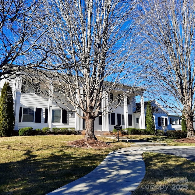 view of front of home featuring concrete driveway and a front yard