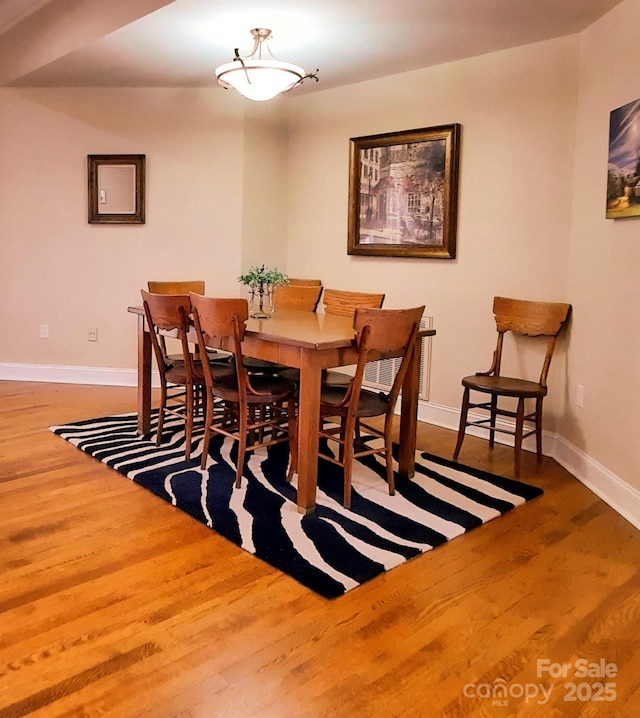 dining room featuring wood finished floors and baseboards