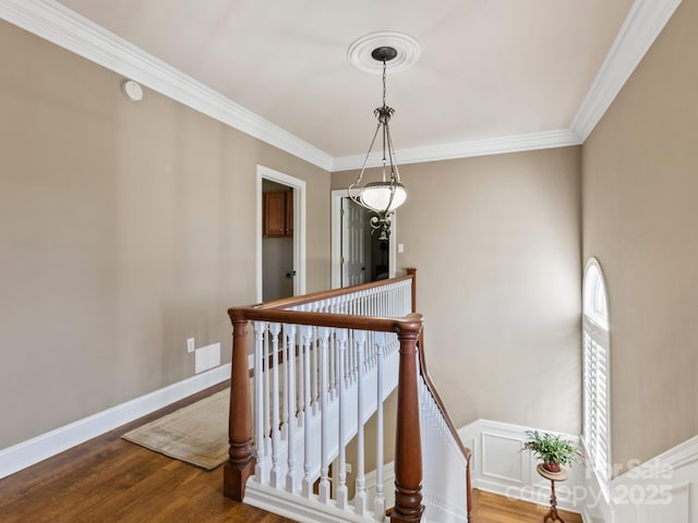 stairs featuring ornamental molding, visible vents, baseboards, and wood finished floors