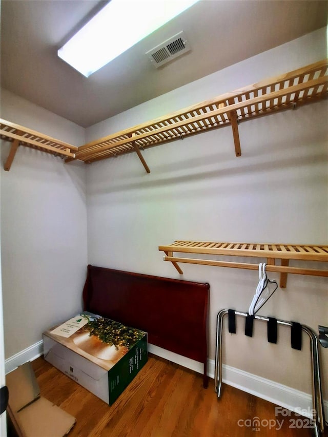 walk in closet with visible vents and wood finished floors