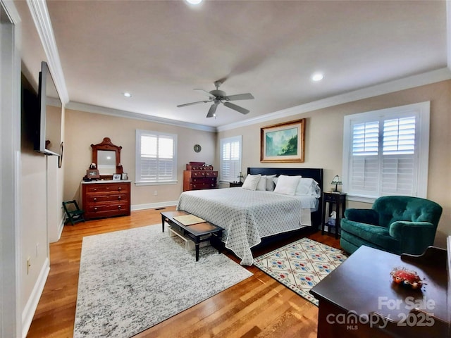 bedroom featuring recessed lighting, crown molding, baseboards, and wood finished floors