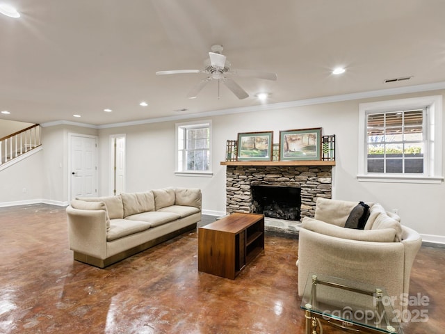 living room featuring crown molding, a fireplace, finished concrete flooring, stairway, and baseboards