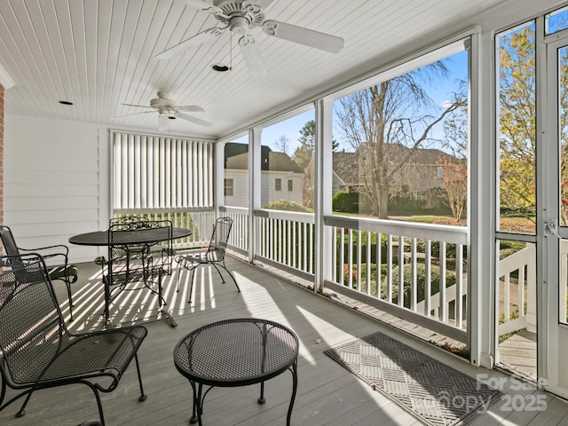 sunroom with wooden ceiling and a ceiling fan