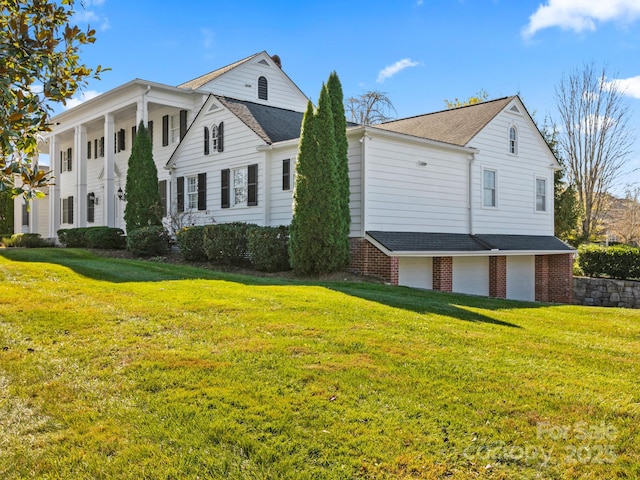 view of front of property featuring a garage and a front yard