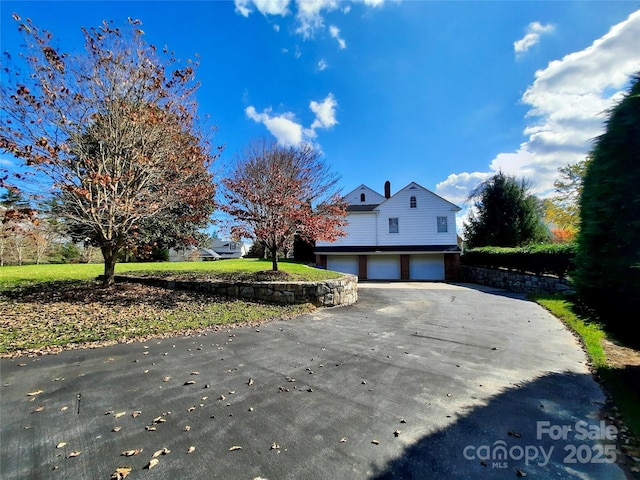 view of front of home with driveway and a garage