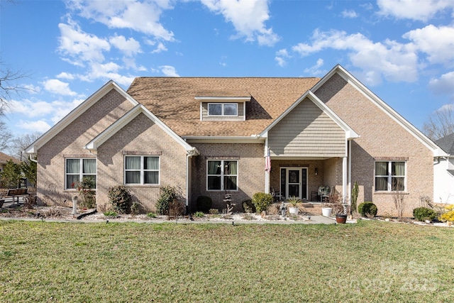 view of front facade featuring a front yard and brick siding