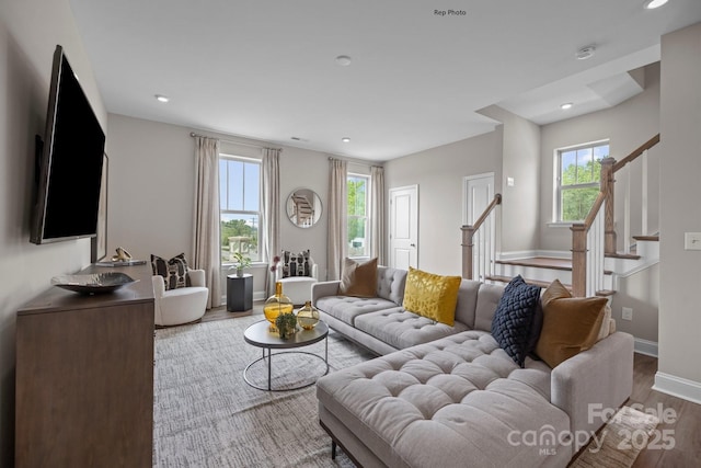 living area featuring stairs, baseboards, wood finished floors, and recessed lighting