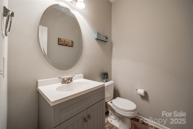 bathroom featuring vanity and toilet