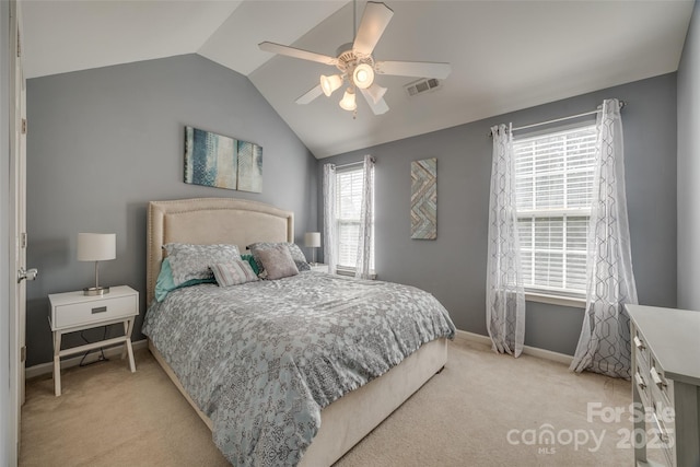 bedroom featuring baseboards, visible vents, light colored carpet, ceiling fan, and vaulted ceiling