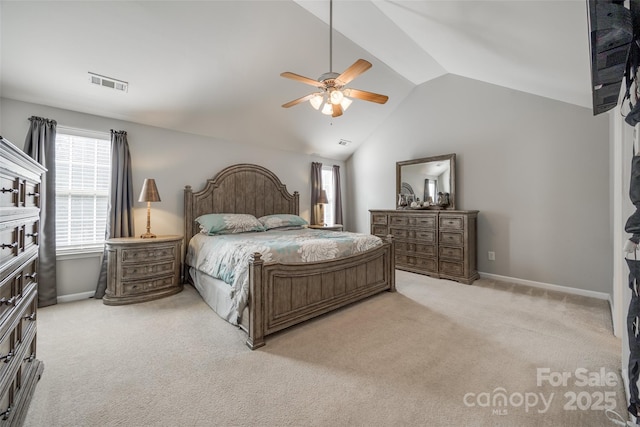 bedroom with lofted ceiling, light carpet, visible vents, and baseboards