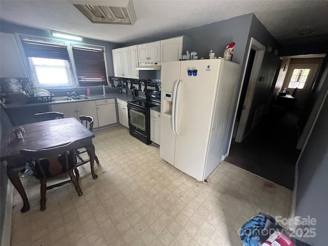 kitchen with electric range, white refrigerator with ice dispenser, white cabinets, under cabinet range hood, and light floors