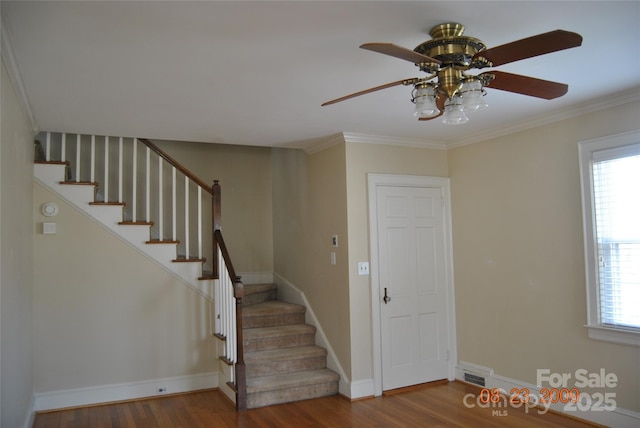 stairway with visible vents, a wealth of natural light, and wood finished floors