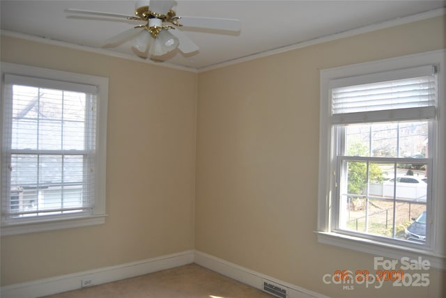 unfurnished room featuring baseboards, visible vents, ceiling fan, and crown molding