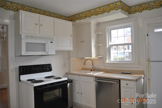 kitchen featuring white appliances, white cabinets, light countertops, open shelves, and a sink